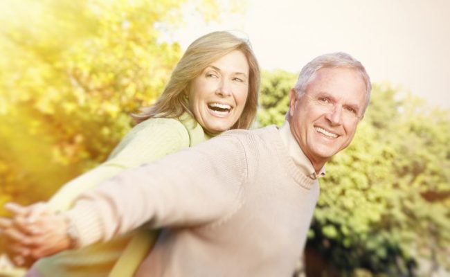 happy senior couple relaxing in the park
