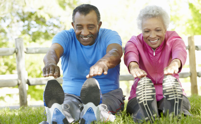 senior african american couple exercising in park